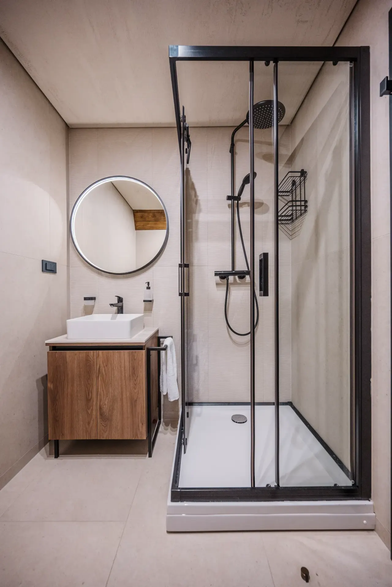 Shower room with a walk-in enclosure, round mirror and timber vanity