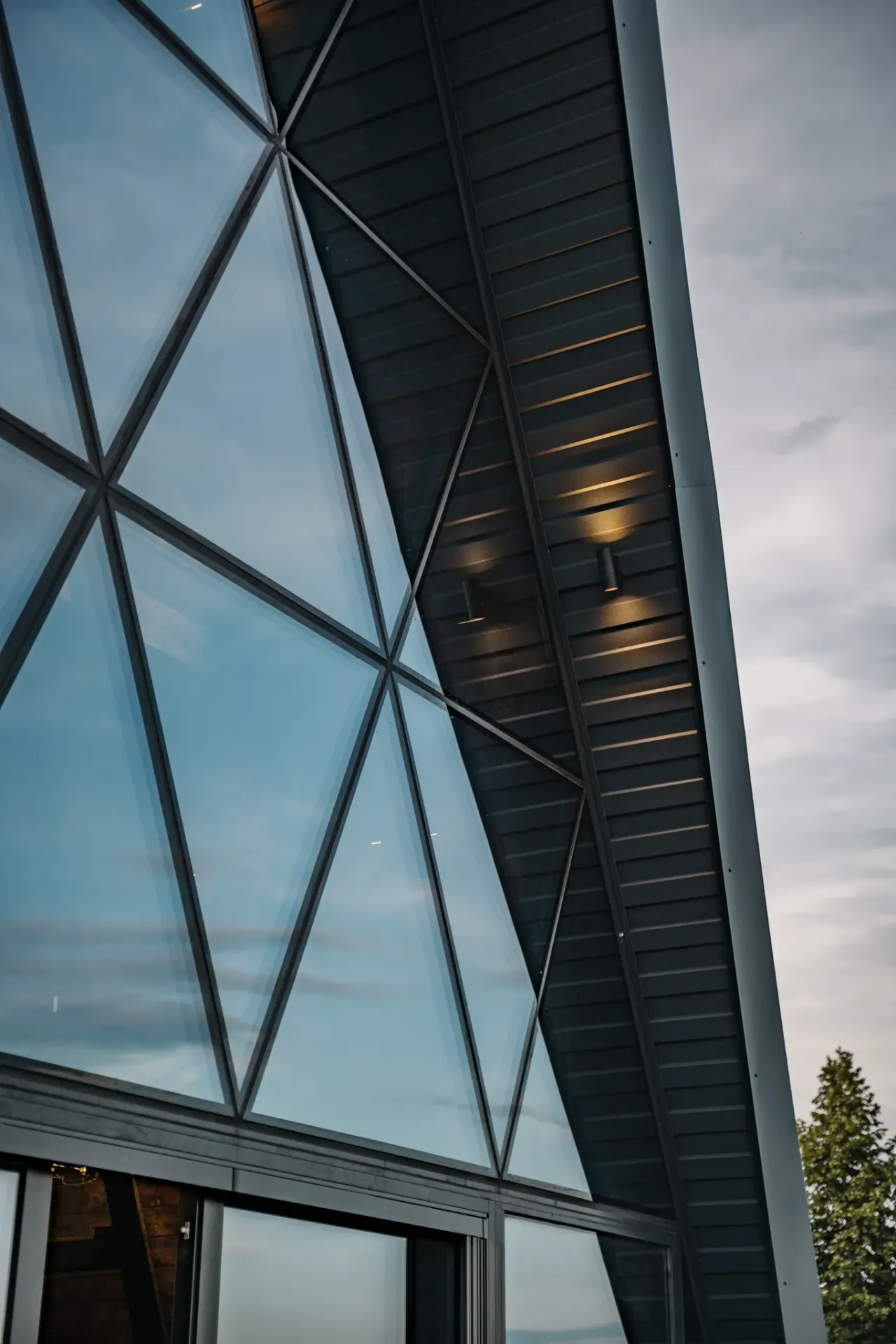 Close study of the triangular glazing bars and standing-seam metal of the A-frame