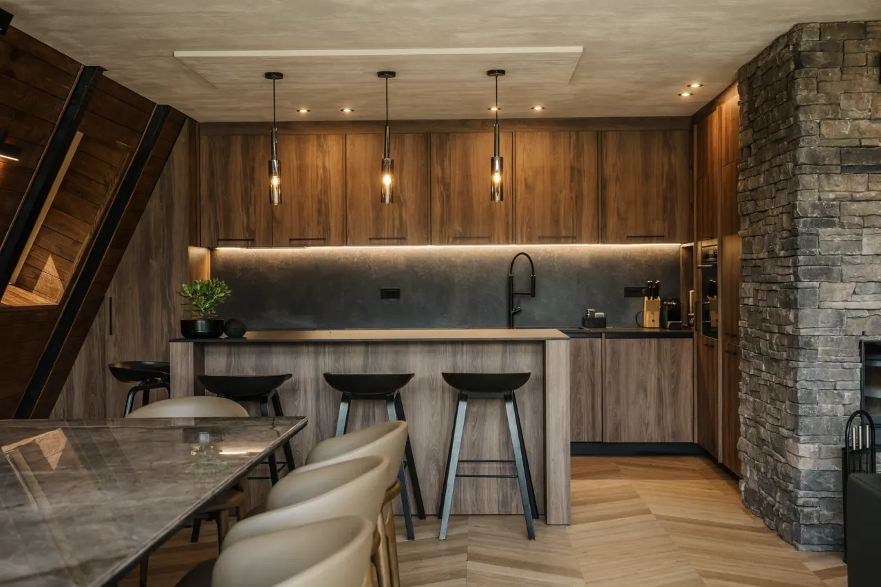 Timber kitchen island with bar stools against a stone feature wall