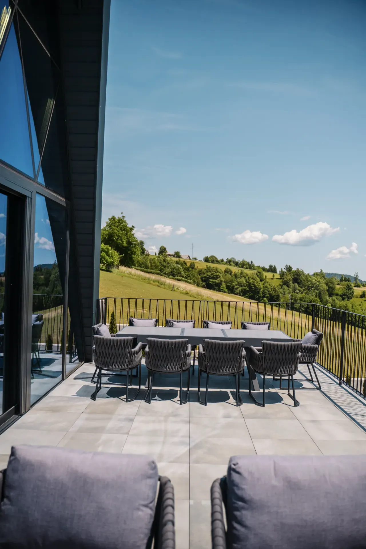 The 40 m² terrace seen from the doorway, dining table set against the Gorski kotar valley