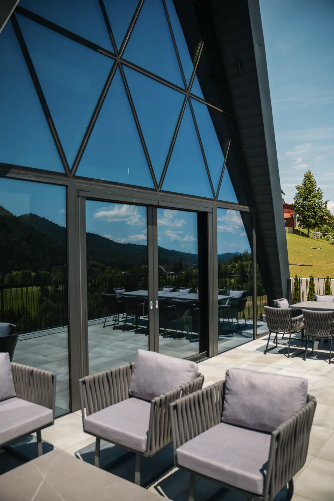 Terrace lounge seating with the triangular glass gable rising above it