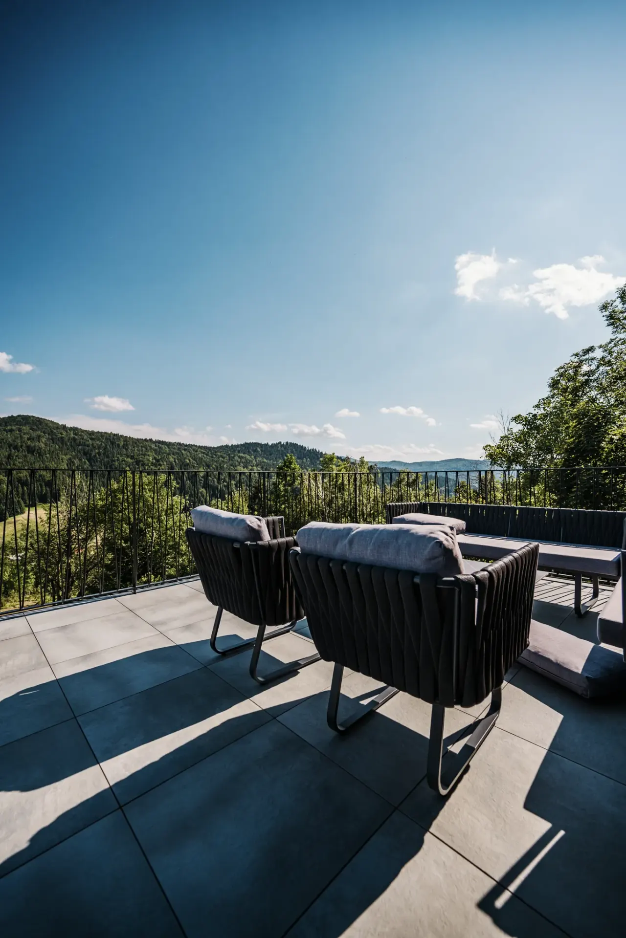 Terrace loungers and low table looking out over the treetops of Gorski kotar