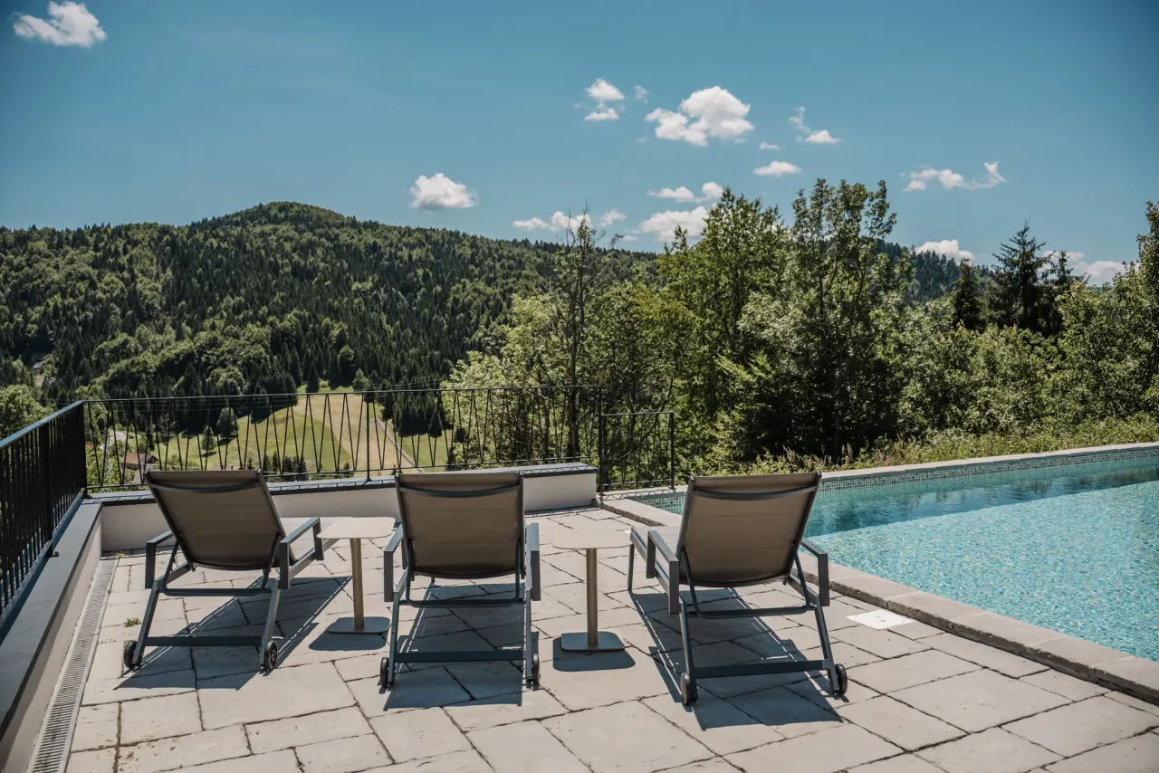 Sun loungers set against the open valley view