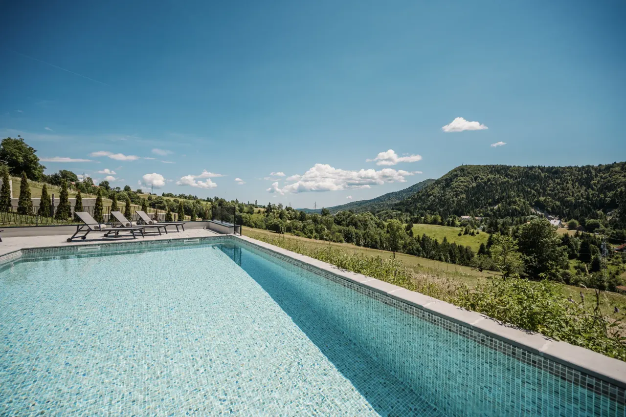 Heated outdoor pool overlooking the wooded hills of Gorski kotar